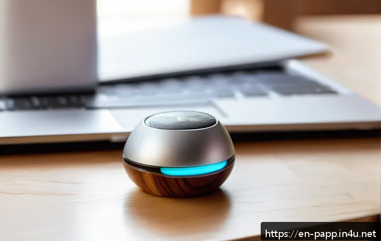 미니 마사지기 장점 - A modern, compact mini massager resting on a sleek wooden desk next to a laptop and a smartphone, so...